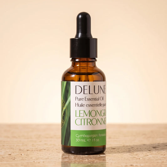 Delune Lemongrass Pure Essential Oil, 30ml amber glass dropper bottle on warm travertine stone